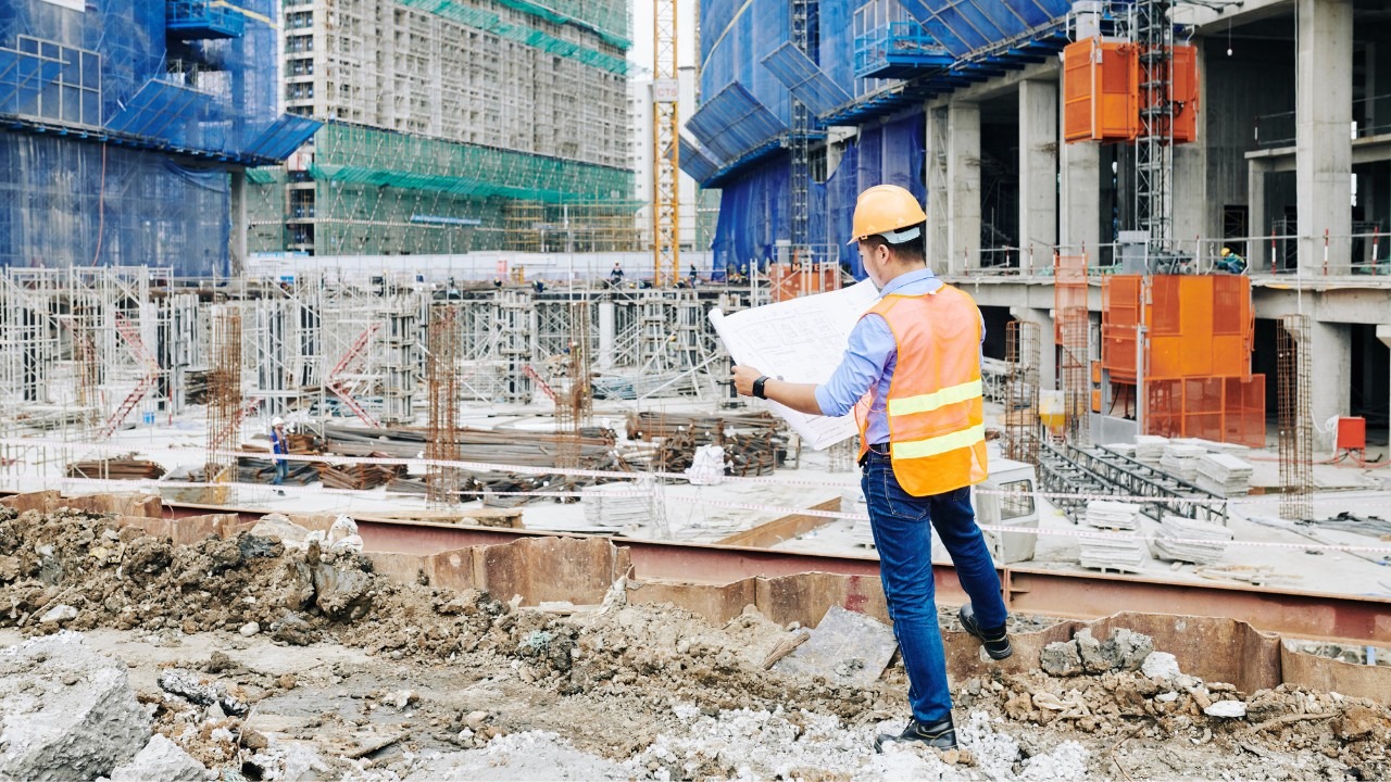 GC looking at building plans on a construction site