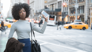 Lady with I-Phone hailing a ride sharing service