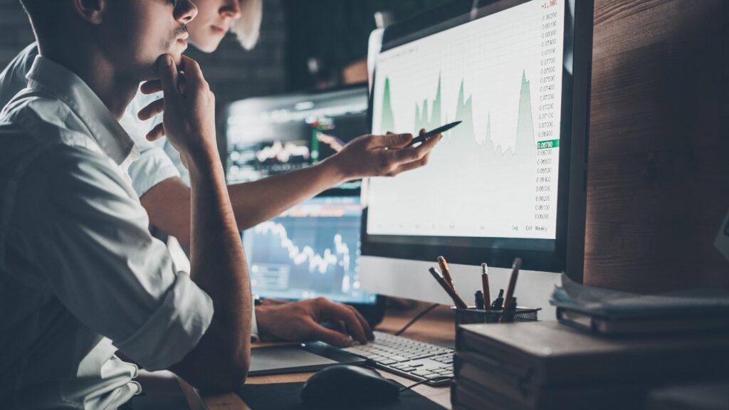 Two employees Analyzing fleet performance data