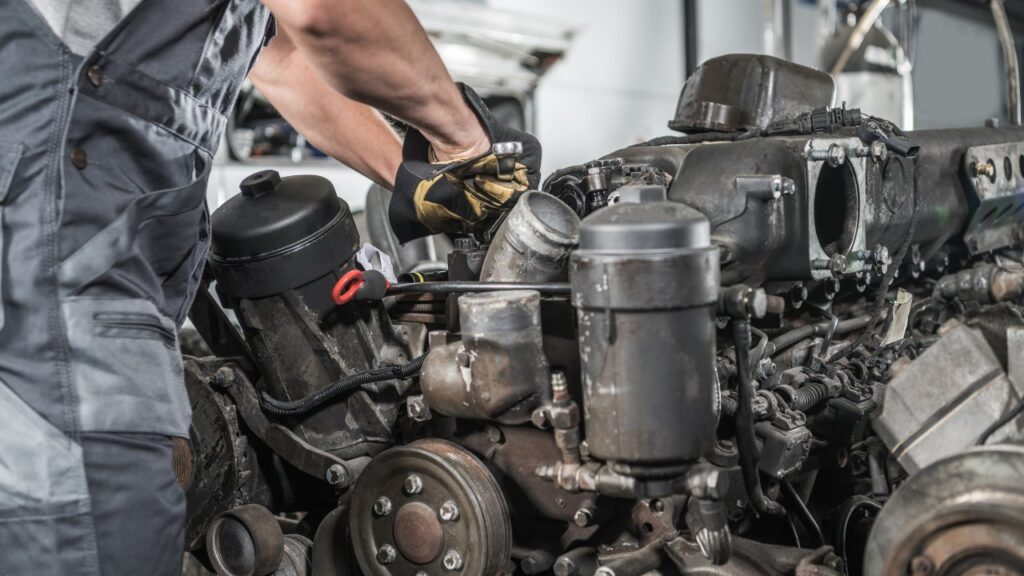 Diesel mechanic working on engine block